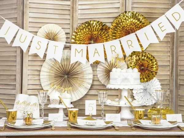 Candles and gold decorations for wedding celebration.
