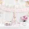 Лента с надпис "Just Married" и цветни декорации за сватбена парти, торта с розови цветя и десерти, създаващ перфектната атмосфера за празник на любов и съвместен живот.