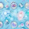 Air freshener, pastel-colored party decorations, paper flowers, balloons, and confetti for celebration or birthday parties.